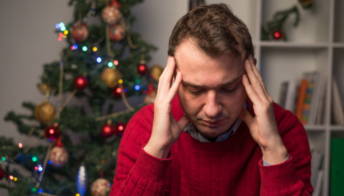 Man touching his head feeling depressed and lonely during the holiday time