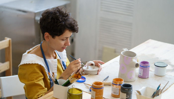 Young girl in short hair trying a new hobby in ceramics